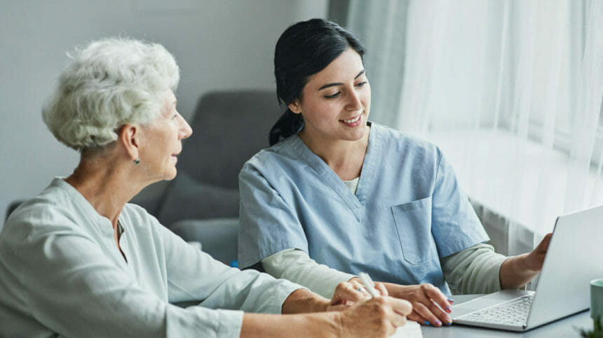 Female Nurse Assisting Senior Woman