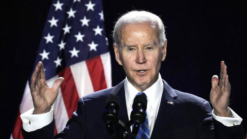 President Biden speaking in front of American flag